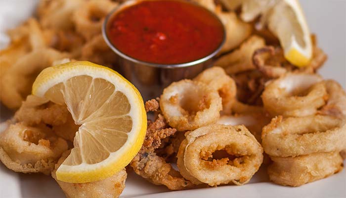 Fried calamari rings with lemon, served at Carini Italian Restaurant Bar Richmond Virginia.