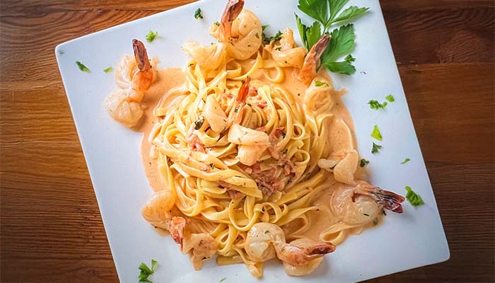 Fettuccine with creamy sauce, shrimp, and parsley at Carini Italian Restaurant Bar Richmond Virginia.