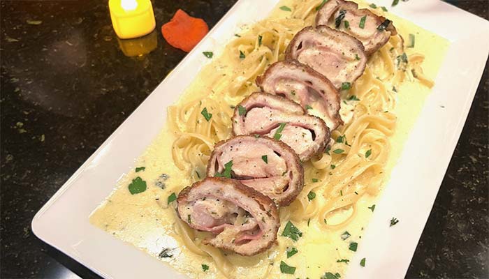 Sliced stuffed chicken on creamy pasta at Carini Italian Restaurant Bar, Richmond, Virginia.