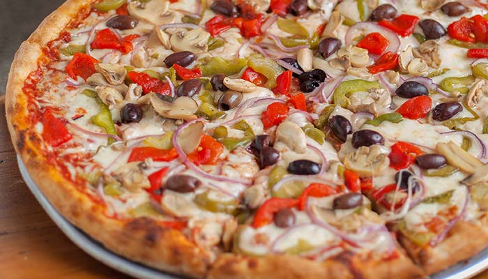 Vegetarian pizza at Carini Italian Restaurant Bar Richmond Virginia, topped with fresh veggies.